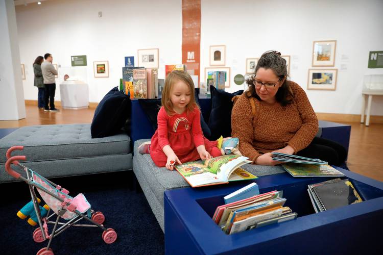 Sarah Nelson of Amherst and Audrey, 4, look through picture books at “Alphabet Soup: How Picture Books Are Made, From A to Z” at the Eric Carle Museum of Picture Book Art.