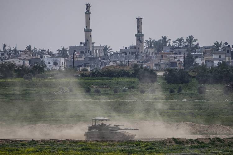 Israeli soldiers drive a tank inside the Gaza Strip, as seen from southern Israel, Tuesday, Feb. 13, 2024. The army is battling Palestinian militants across Gaza in the war ignited by Hamas’ Oct. 7 attack into Israel.