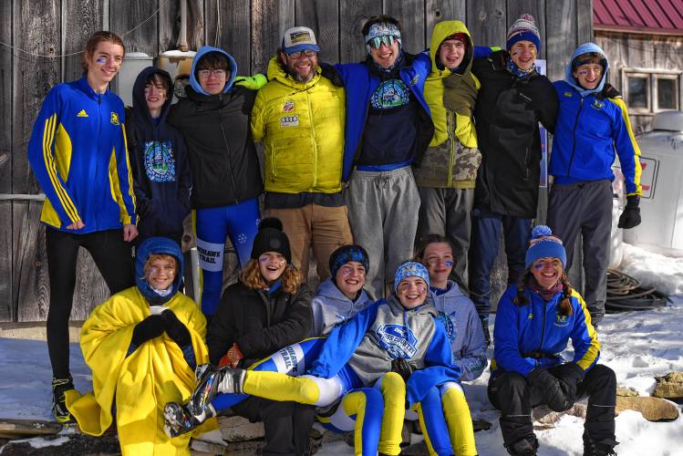 The Mohawk Trail girls and boys teams pose at the MIAA Nordic Ski Championships at Prospect Mountain in Woodford, Vt. on Wednesday.