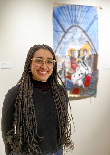Artists and architect Sydney Rose Maubert stands by her paint on fabric work, “Cartographies of Braiding,” at “As We Move Forward” in the Augusta Savage Gallery at UMass Amherst.