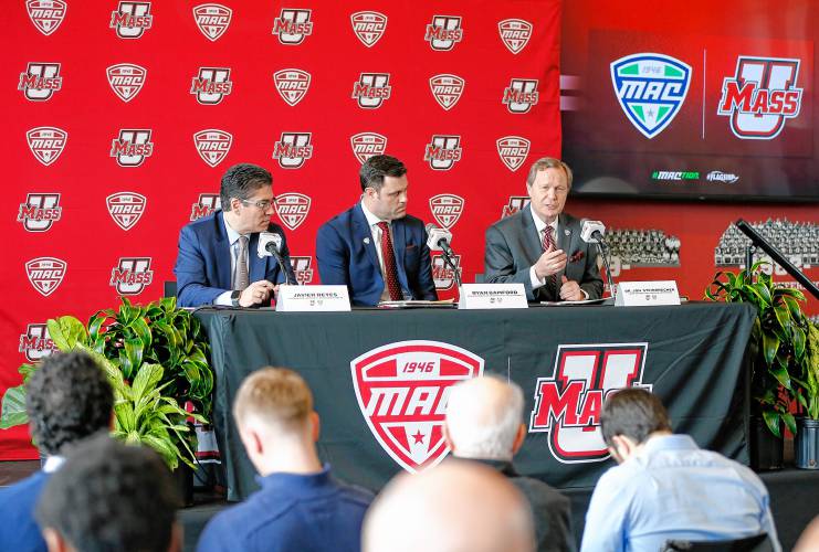 Chancellor Javier Reyes, from left, Director of Athletlics Ryan Bamford and MAC commissioner Dr. Jon Steinbrecher speak during a press conference at the Martin Jacobson Football Performance Center on Thursday regarding the University of Massachusetts joining the Mid-American Conference.