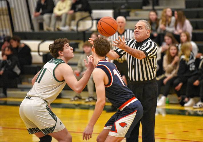 Referee Mark Grumoli tosses the jump ball to start the game between the Greenfield and Frontier boys basketball teams at Nichols Gymnasium in Greenfield on Jan. 23.