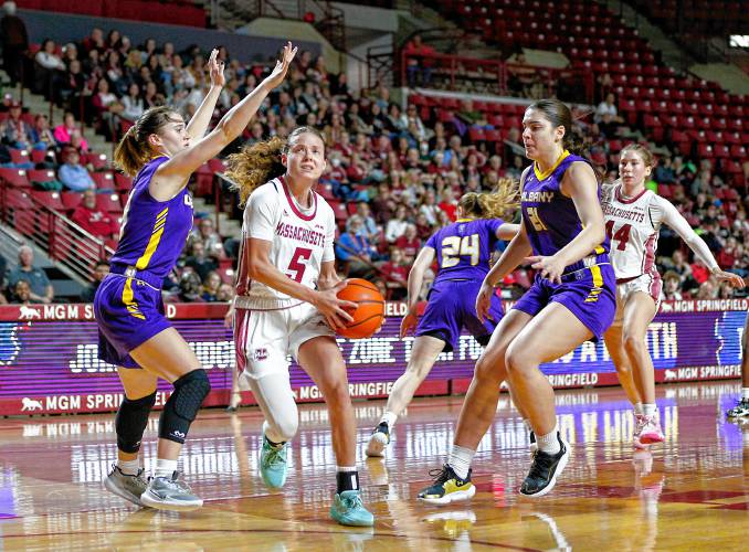 UMass guard Kristin Williams (5) drives to the hoop against UAlbany earlier this season.
